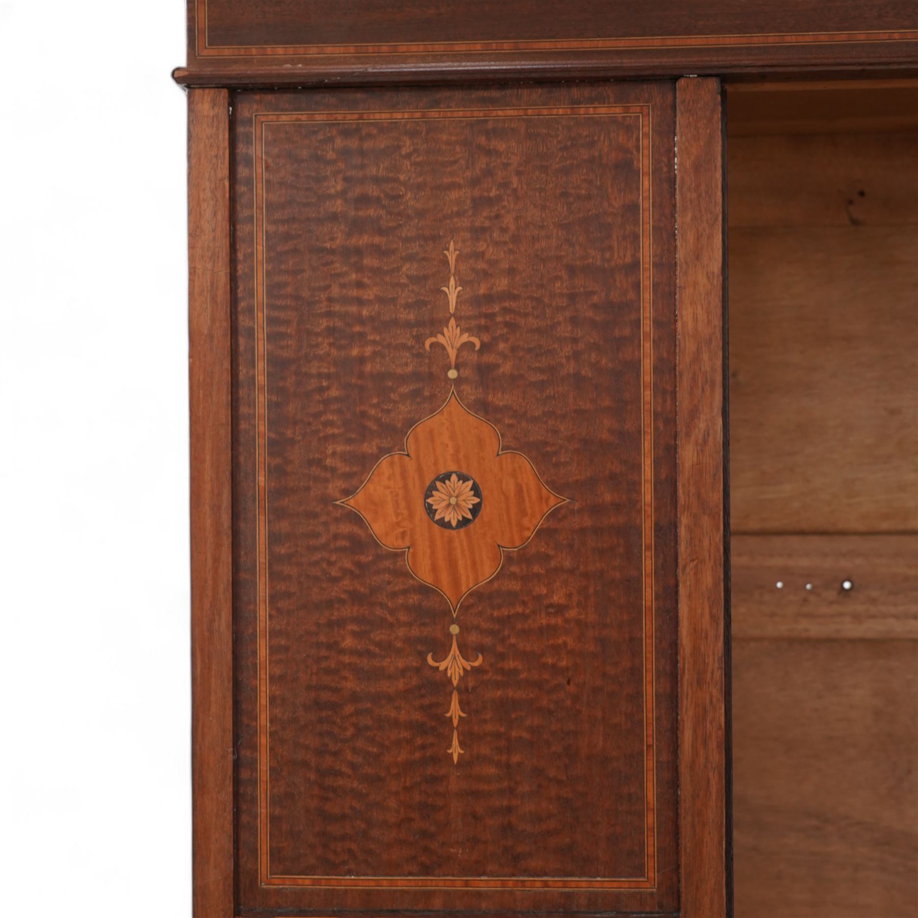 Edwardian inlaid mahogany wardrobe, projecting moulded cornice over panelled front and central bevelled mirror door, inlaid with satinwood shaped panels and trailing bell flowers, geometric inlaid bands and satinwood bands, single drawer to base, on bracket feet 