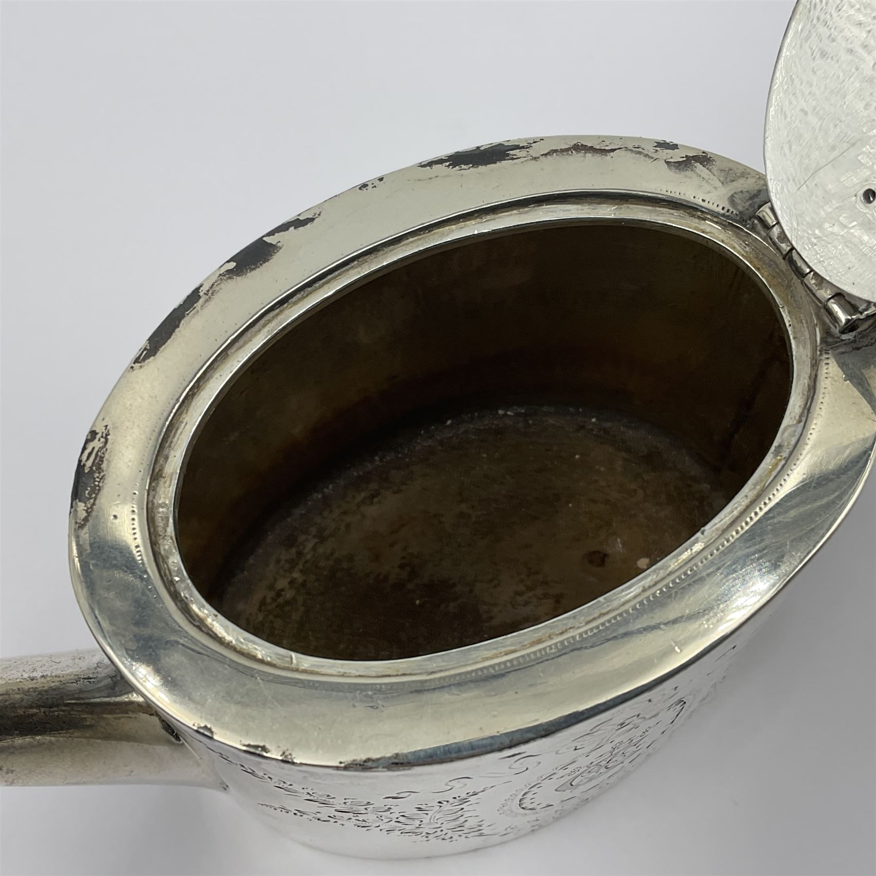 George III silver bachelors teapot, of oval form with wooden scroll handle and finial, the body chased with armorial crest and ribbon swag and foliate detail, hallmarked Samuel Godbehere & Edward Wigan, London 1793, including handle H9cm