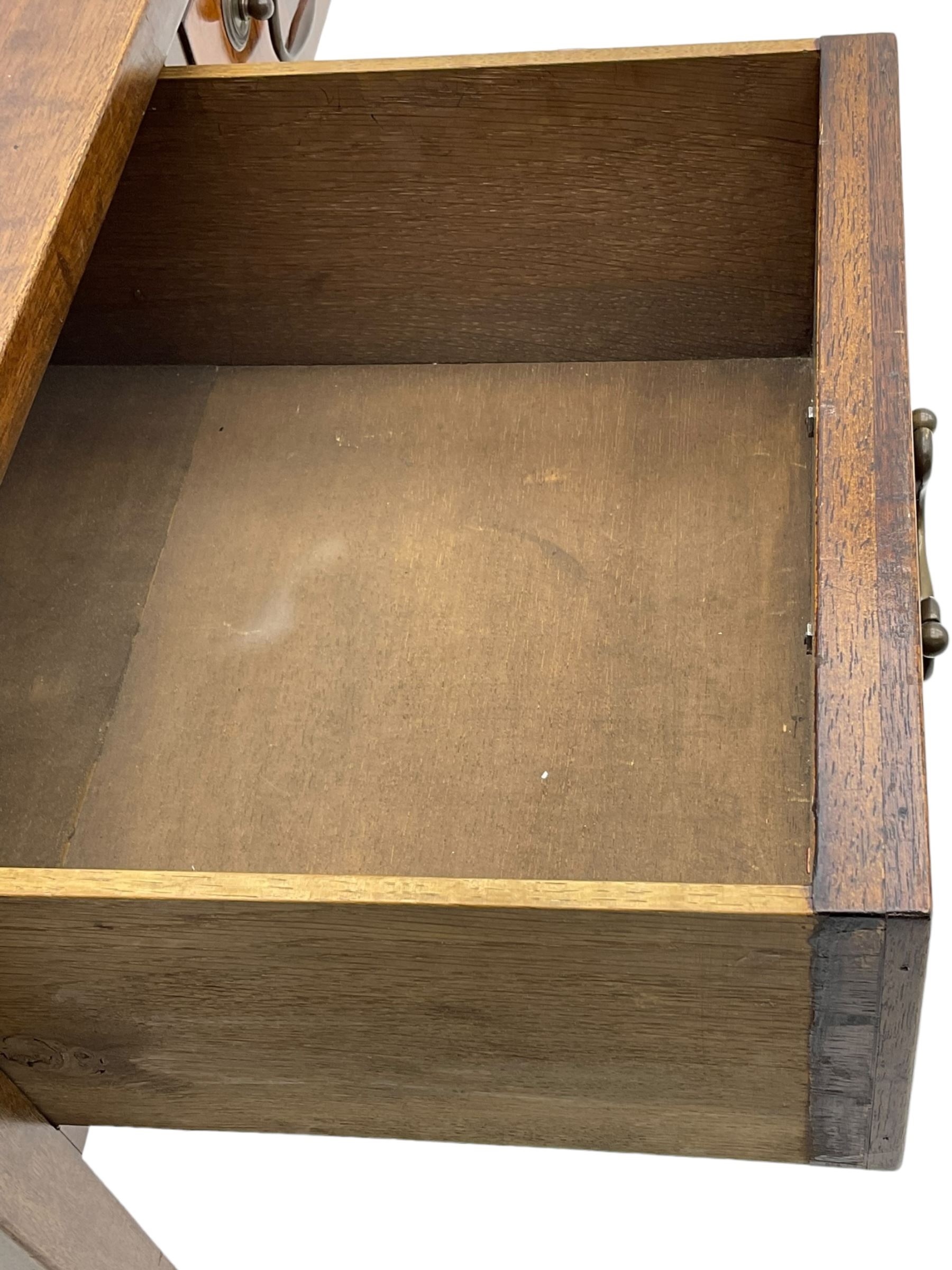 Mid-to-late 20th century mahogany writing desk, the rectangular top with a tooled red leather insert bordered with gilt detailing, three cock-beaded drawers with brass handles, the narrow central drawer flanked by two wider drawers, standing on square tapered legs