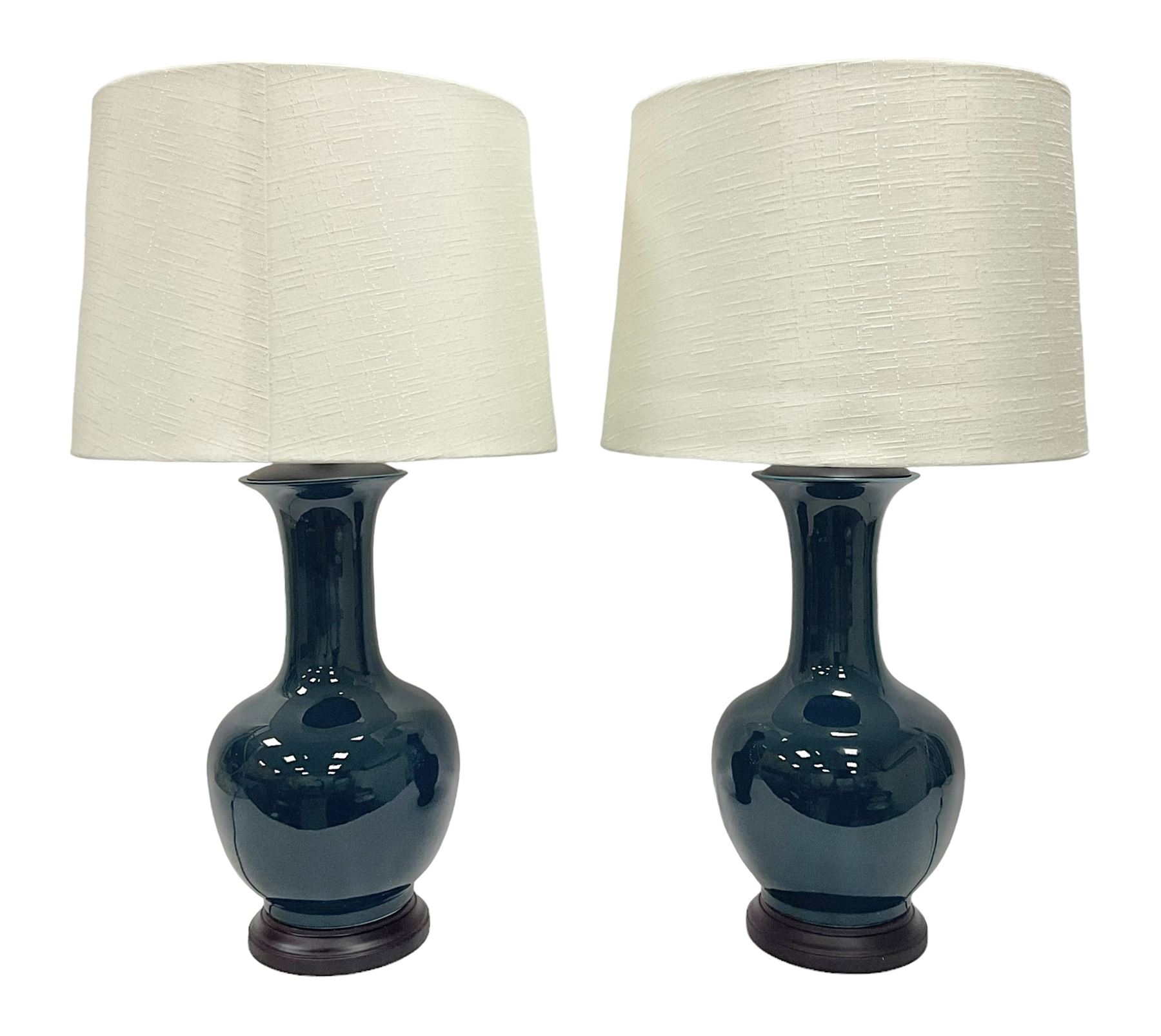 Pair of Chinese teal glazed table lamps, each of bottle form, raised upon circular hardwood bases, including shade H72cm 