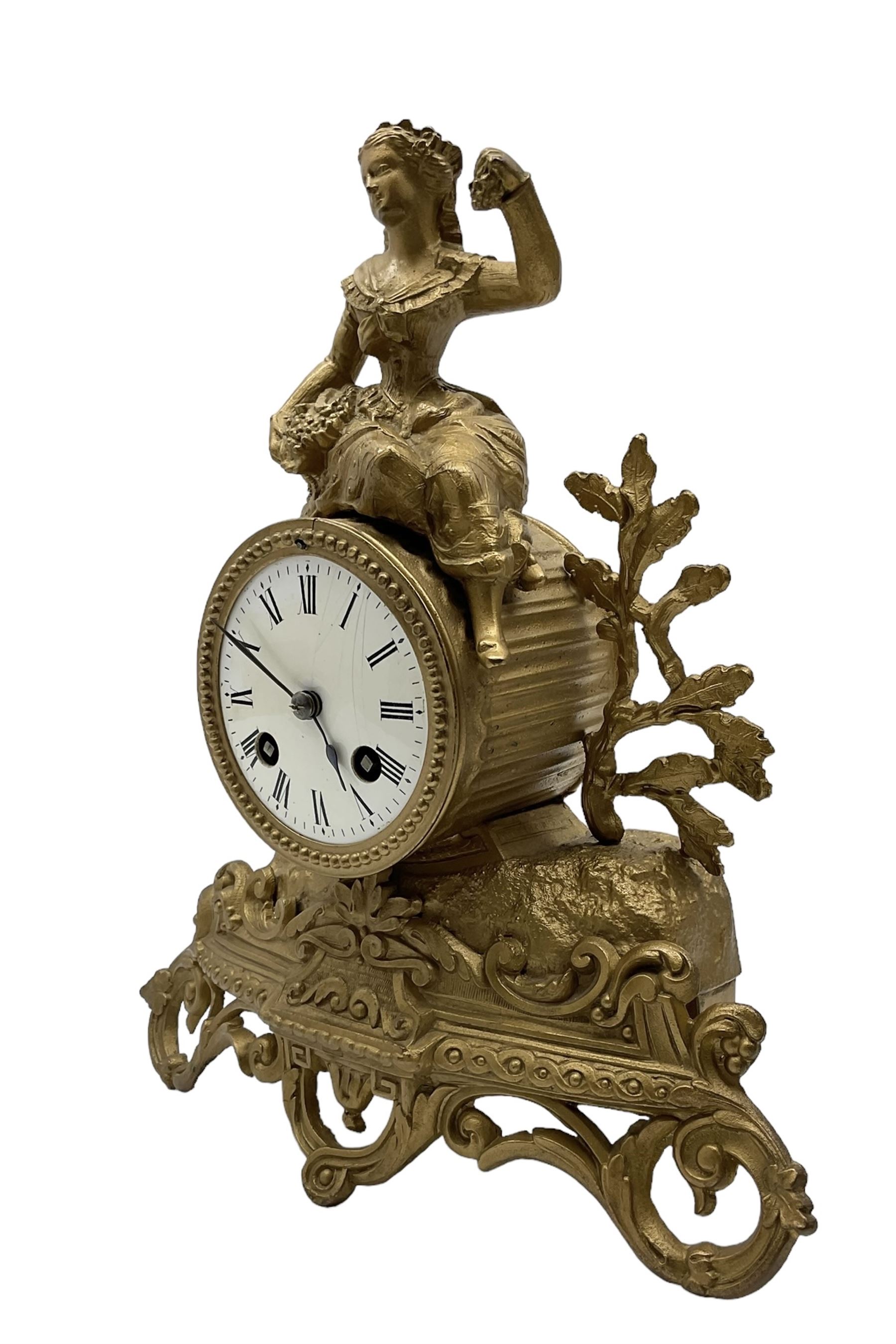 French - late 19th century 8-day mantle clock, in a spelter case with a solitary maiden seated above the drum movement, with an enamel dial, Roman numerals, minute markers and spade hands, twin train countwheel striking movement striking the hours and half hours on a bell. With pendulum and key. 