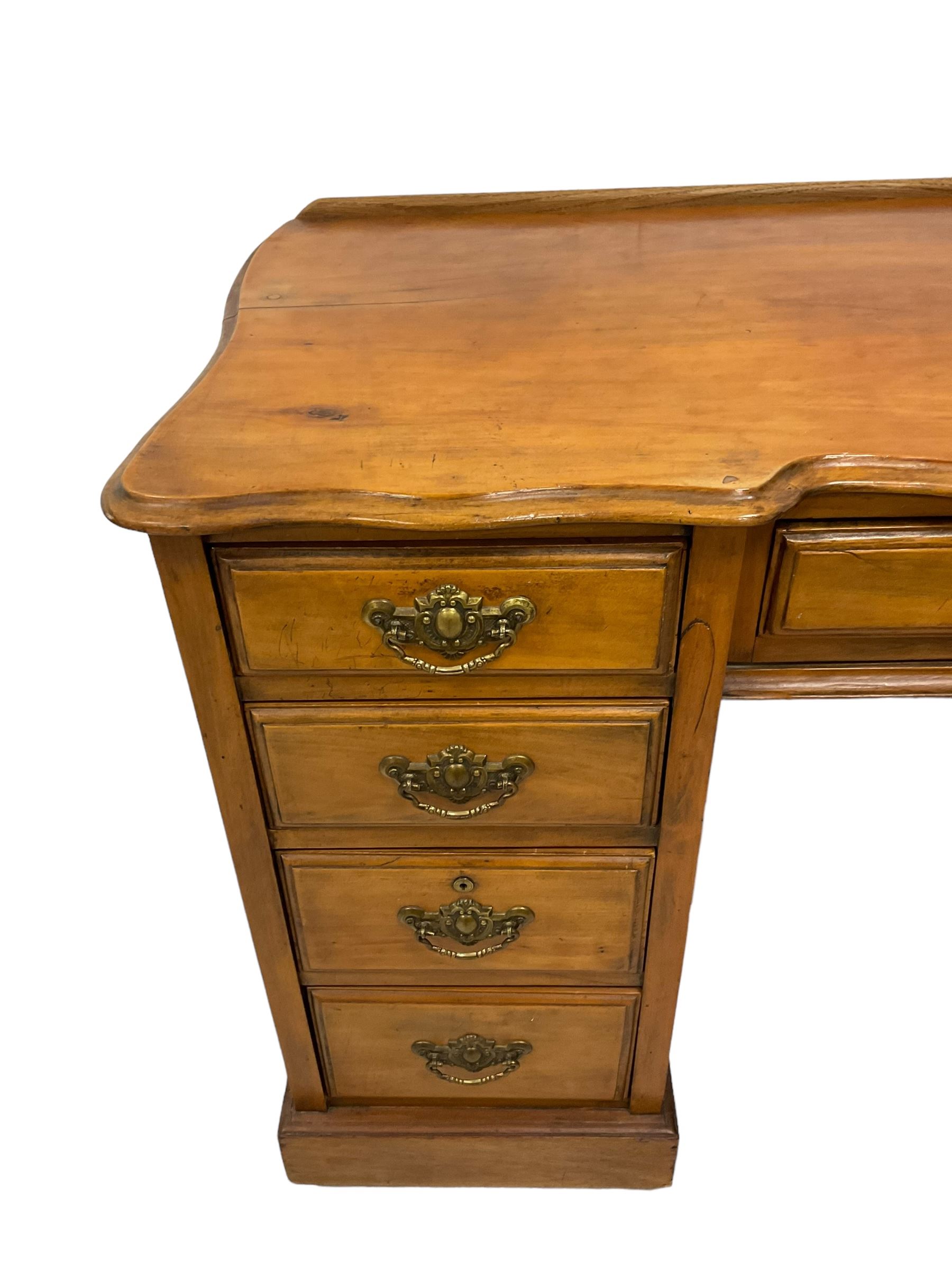 Late 19th century walnut twin pedestal desk, shaped moulded top over nine drawers, on moulded plinth base 