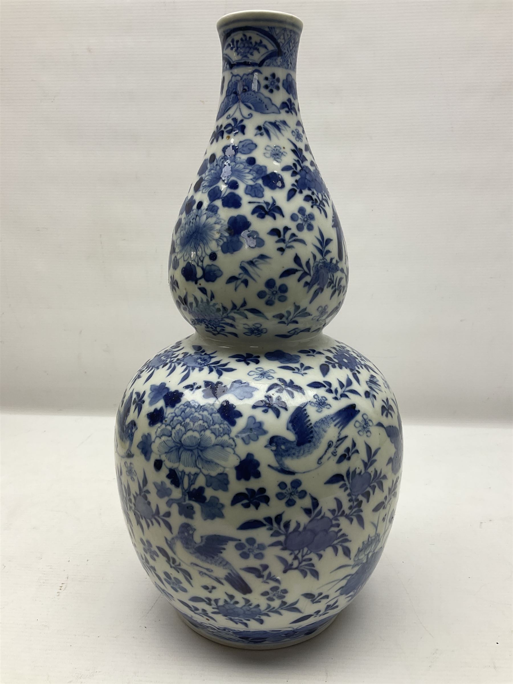 19th century Chinese blue and white double gourd form vase, decorated with blooming peonies and birds in flight, H36cm