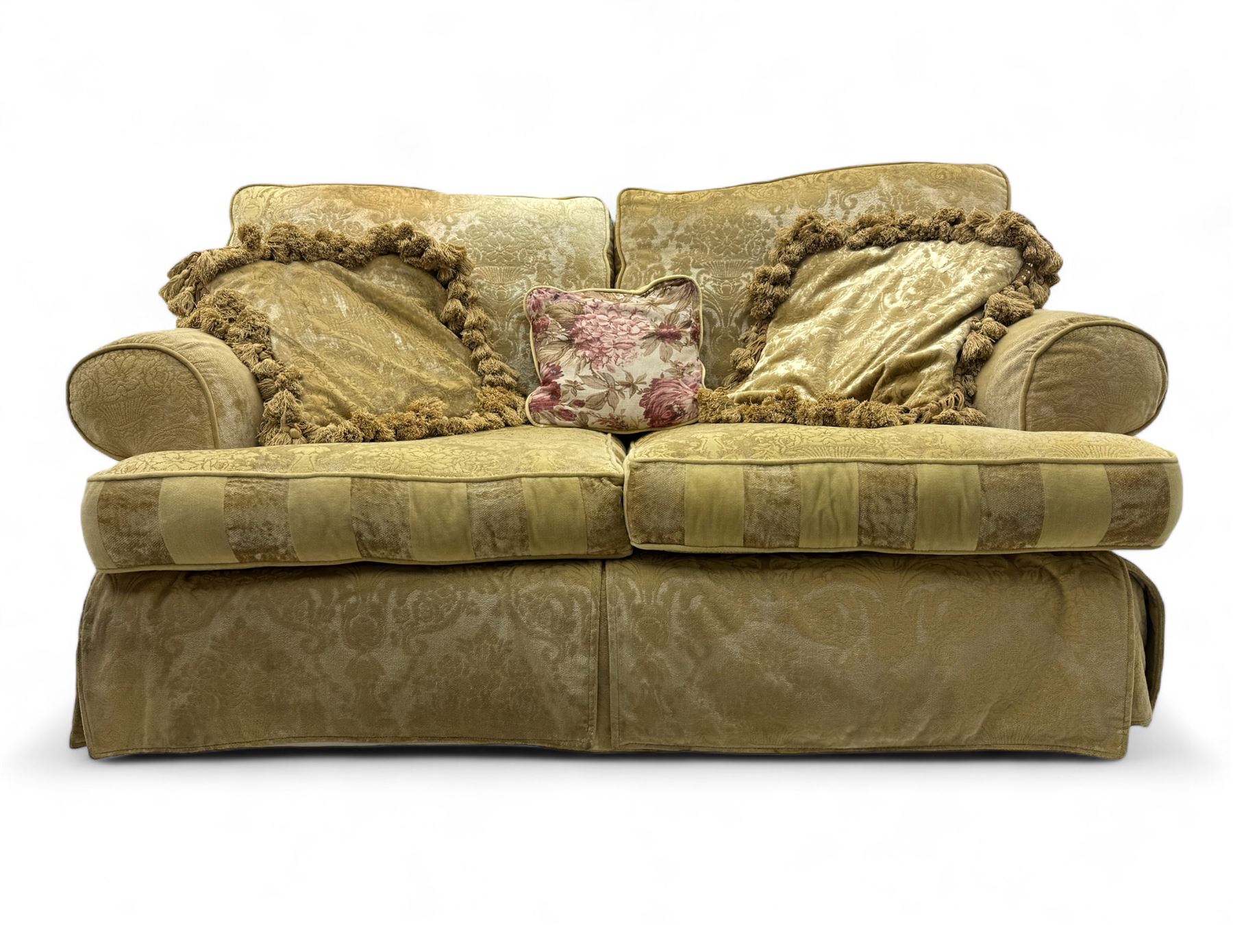 Contemporary two-seat sofa, upholstered in damask fabric with a pale gold floral pattern, rolled arms, loose back and seat cushions, on matching skirted base with concealed castors