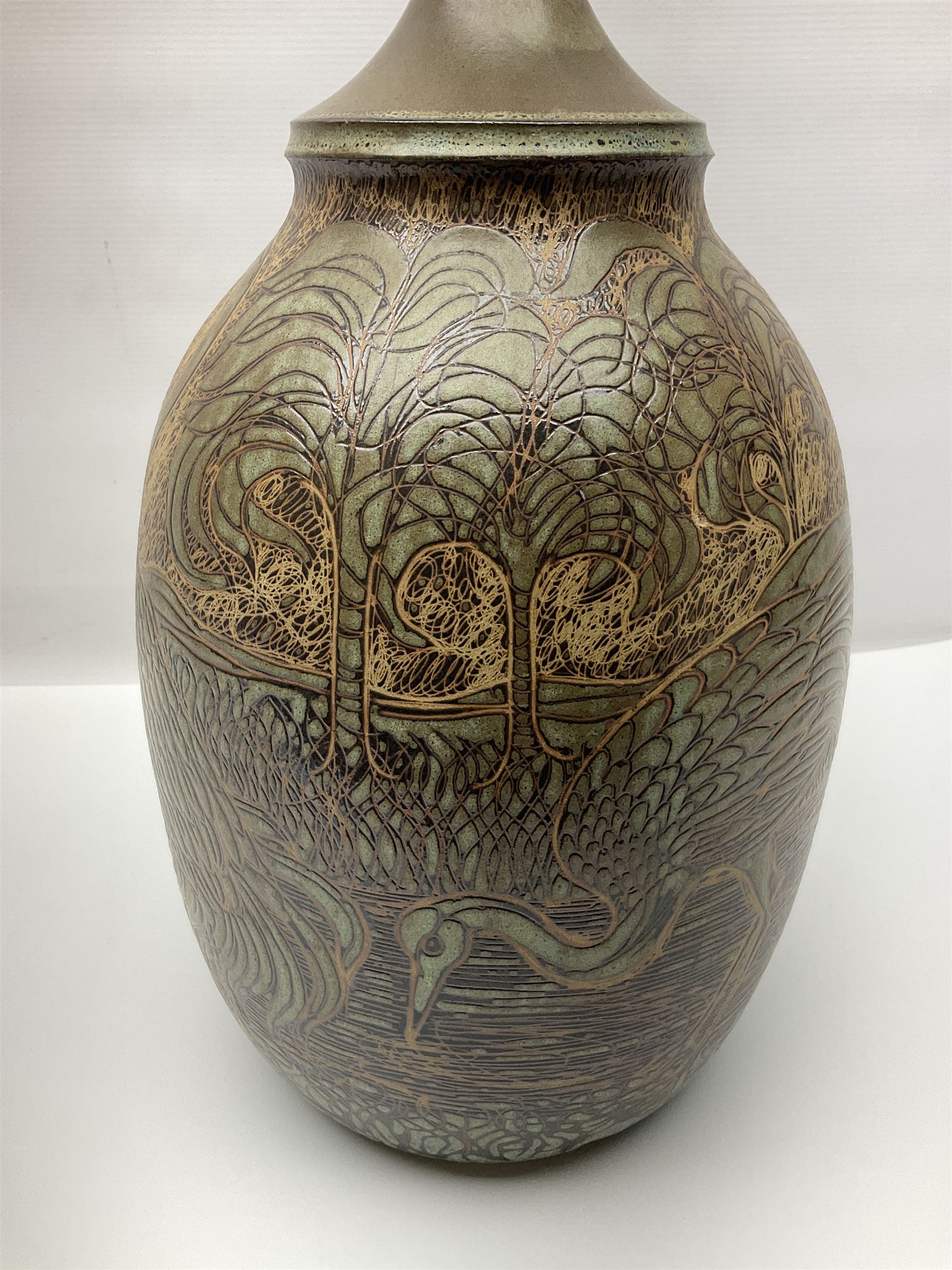 John Egerton (c1945-): studio pottery stoneware lamp base, decorated with cranes in a riverscape upon a mottled brown ground, H51cm