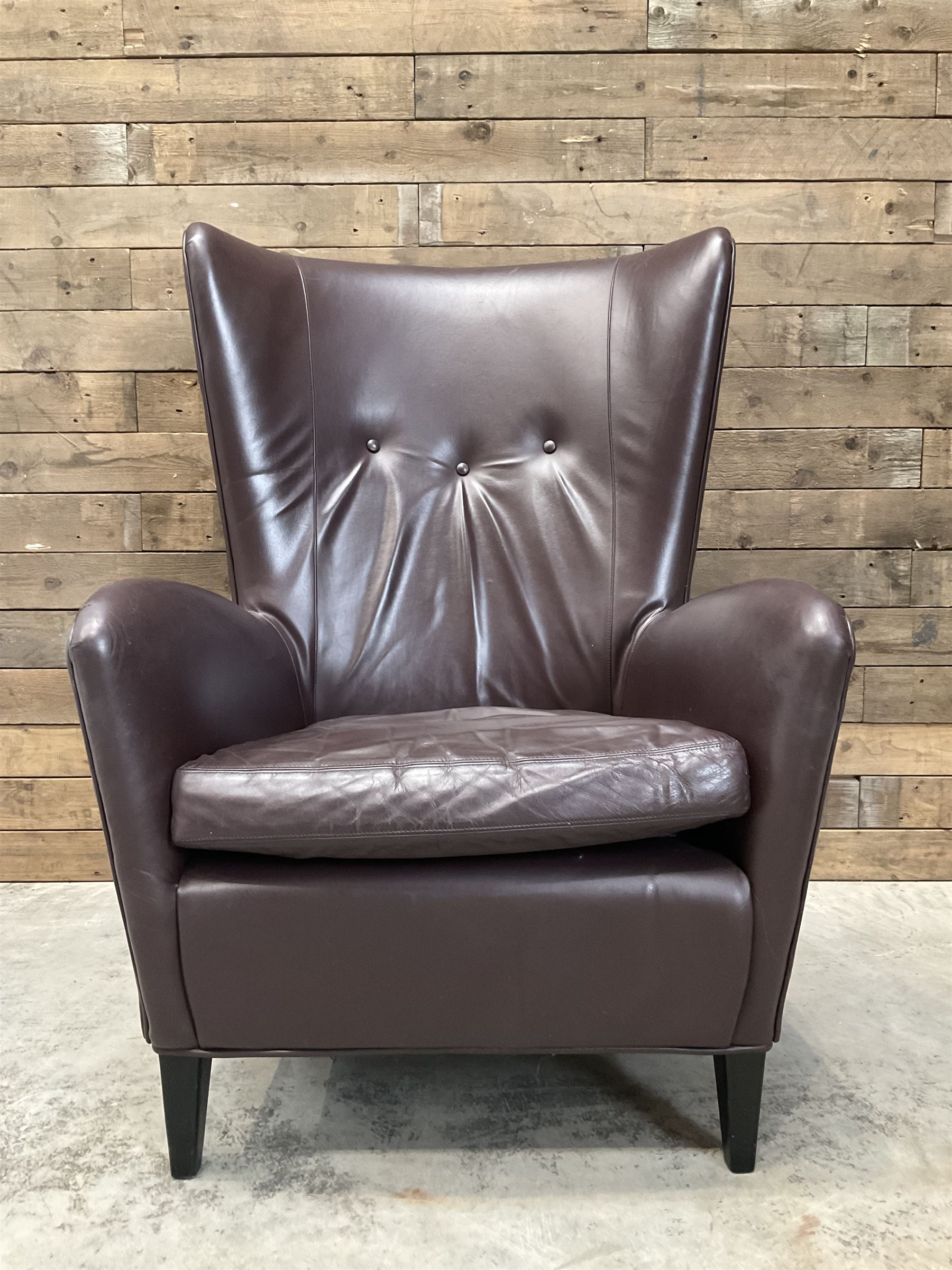 Wing back armchair upholstered in cocoa brown leather