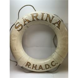 Four mid 20th century yacht lifebuoys, each painted in gold and black lettering 'Sarina R.H.A.D.C', upon a white ground, D68cm