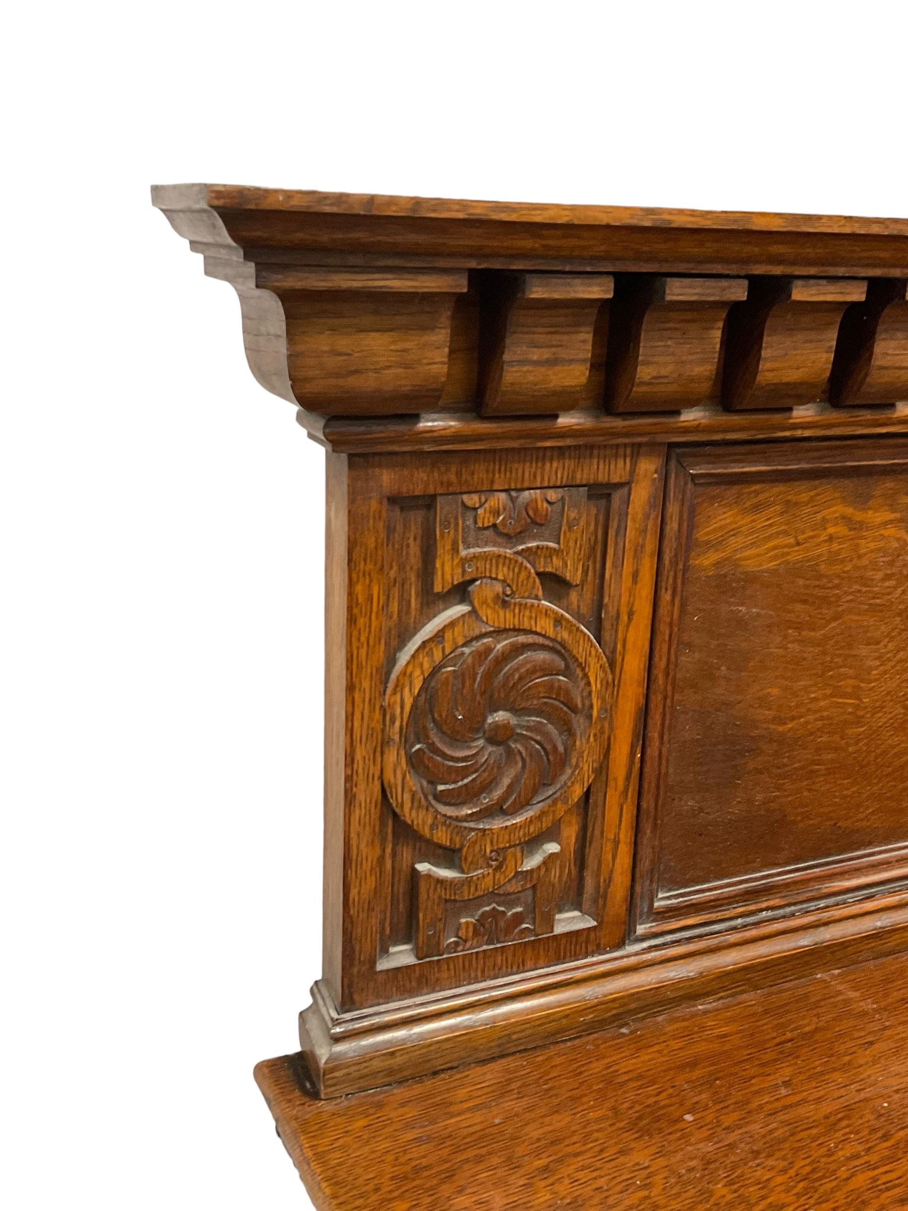 Early 20th century oak sideboard, raised panelled back with foliate carved decoration, rectangular top with gadrooned edge, fitted with two drawers over cupboards with field moulded facias, turned supports joined by stretchers