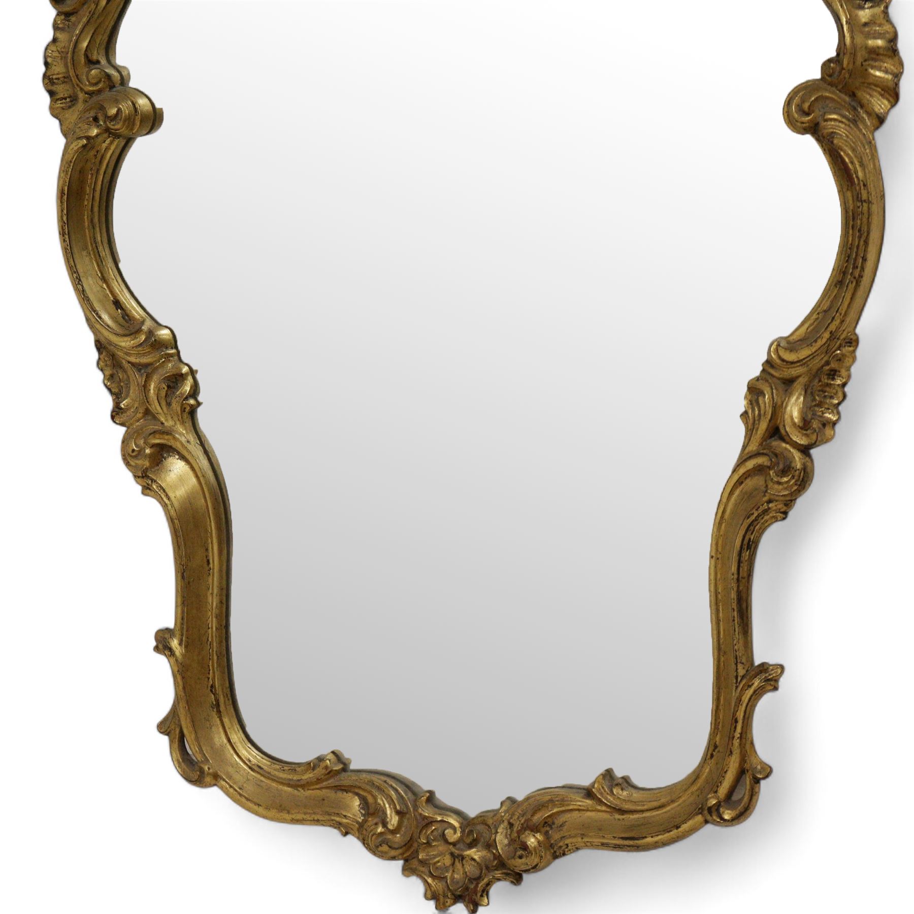 Ornate gilt framed wall mirror, shell pediment over scrolled foliate frame enclosing plain mirror plate