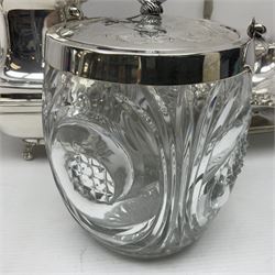 Edwardian silver plated swing handled basket, with pierced sides, engraved May 18 1904, with engraved initial A to handle, upon four ball and claw feet, together with other silver plated item including a similar swing handled basket, with embossed floral border, upon a rectangular pedestal, an egg coddler, with lion mask handles, hot water pot and a moulded glass biscuit barrel, coddler H22cm