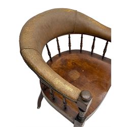 Pair of late Victorian walnut tub-shaped elbow chairs, the cushioned cresting rail upholstered in leather on spindle turned supports, dished saddle seat on turned supports