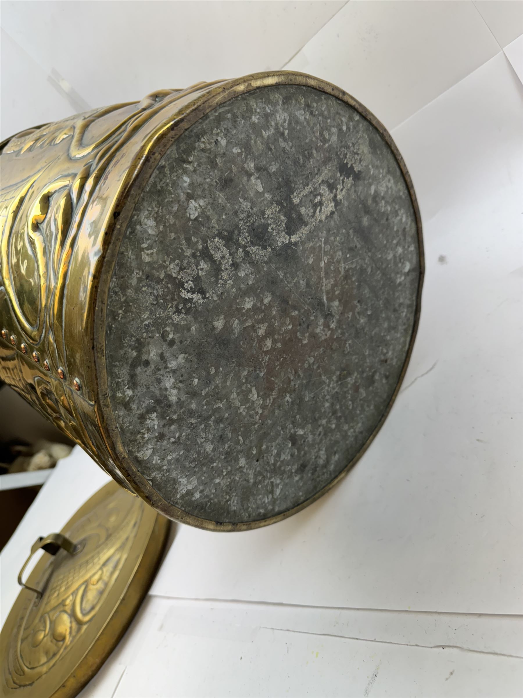 Arts and Craft brass coal box of cylindrical, with embossed stylised leaf panels, with twin handles, the cover with triform handle, H42cm 