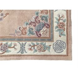 Chinese washed woollen pink ground rug, decorated with floral bouquets and Chinese symbols 