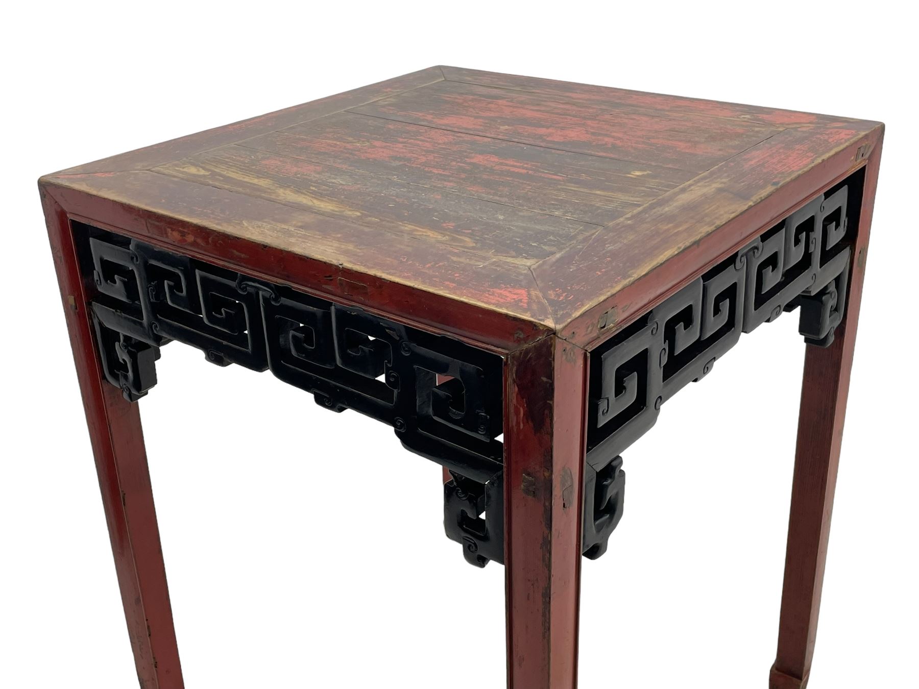 Late 19th century Chinese Qing dynasty red and black lacquered wood tall tea table, Shanxi region, square top over geometric scroll fretwork panels, on square supports with hoof feet 