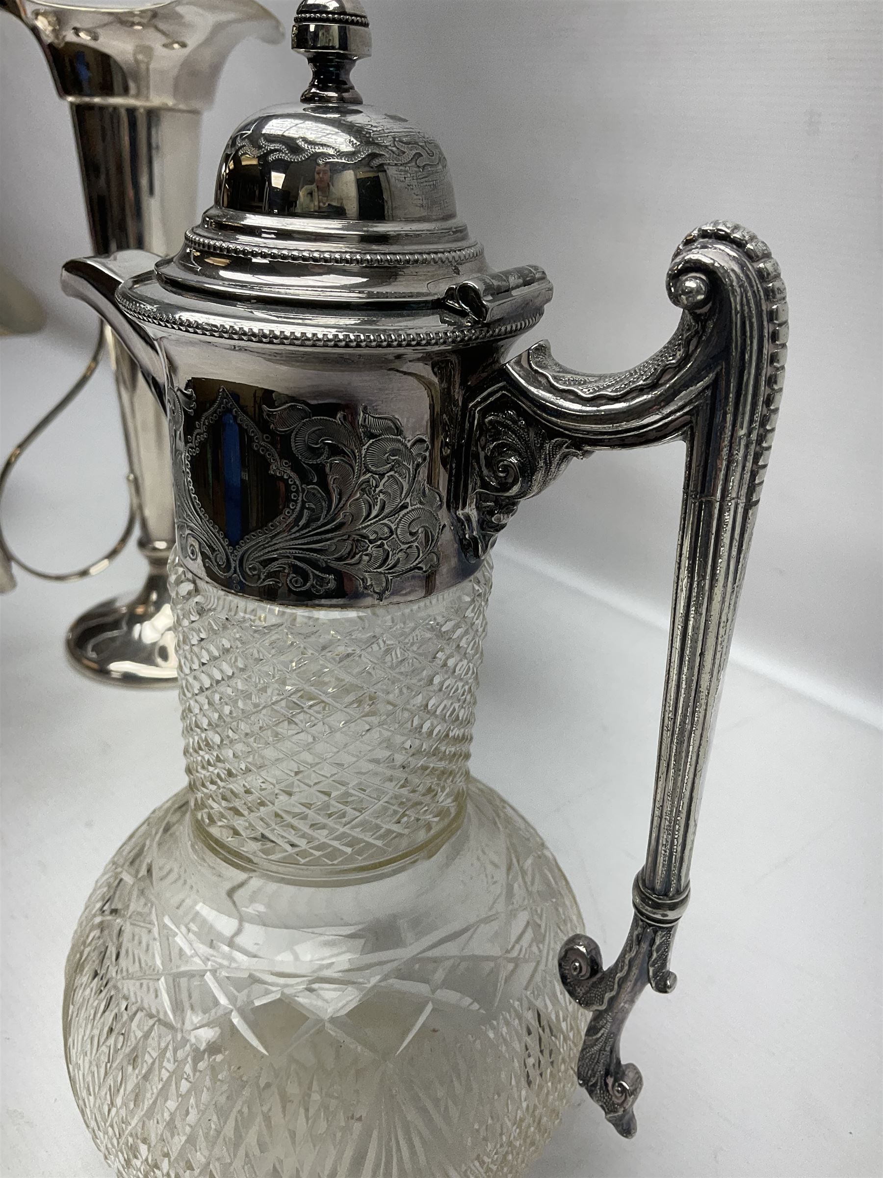 Silver plated three branch epergne, together with a silver plated cut glass claret jug, and silver plated embossed swing handled basket, epergne H30.5cm