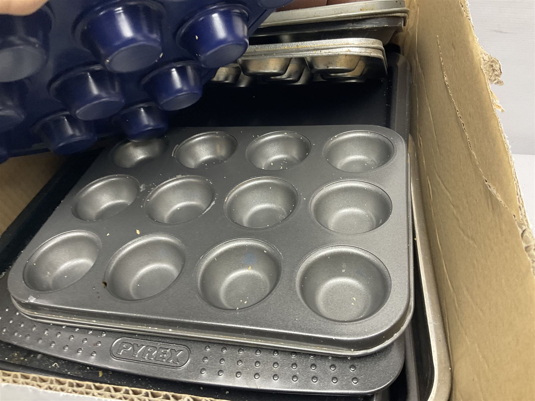 Large collection of kitchen and baking equipment, including cutlery, baking trays, ramakins, utensils, etc, in three boxes 