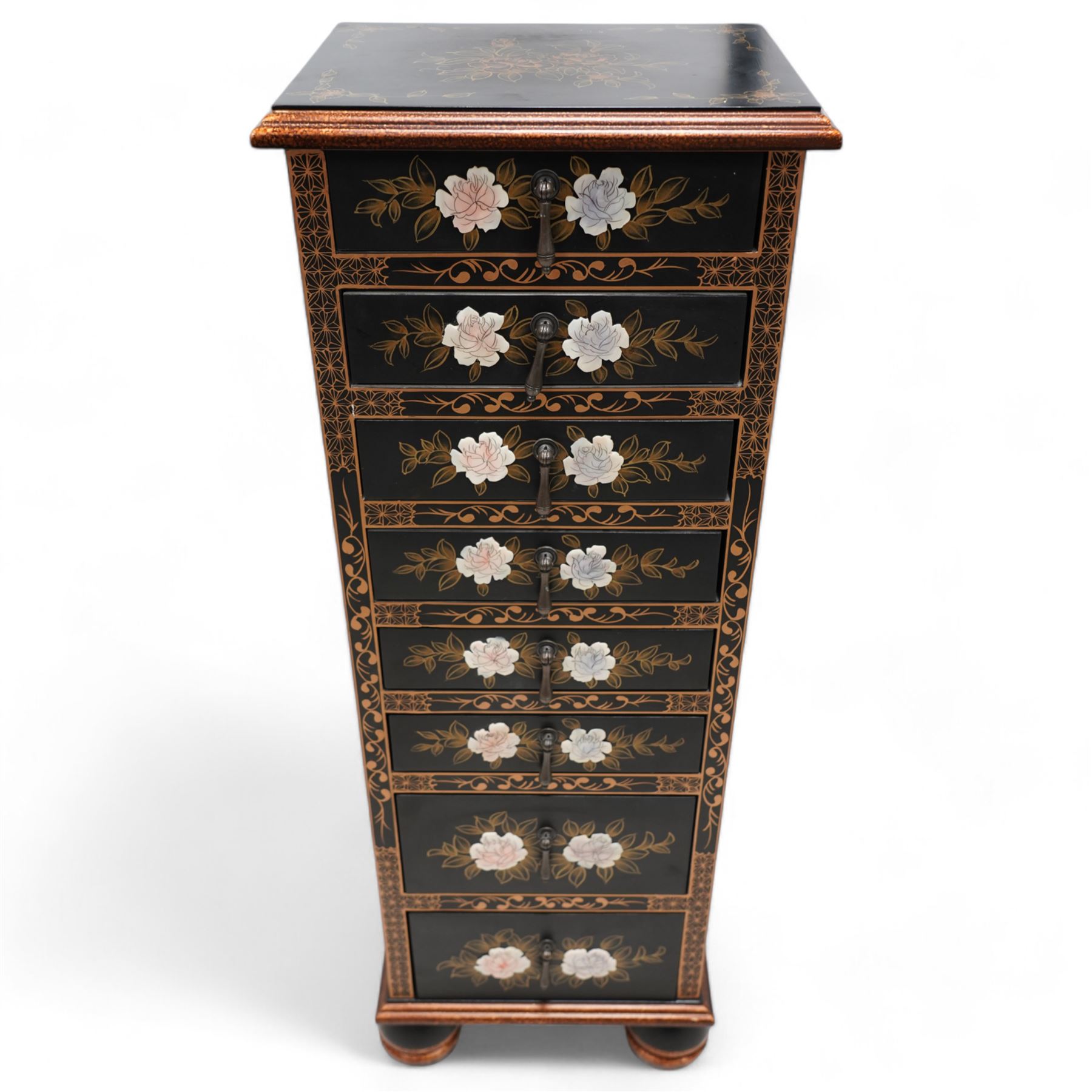 Chinoiserie decorated black lacquered pedestal chest, rectangular moulded top decorated with gilt floral patterns, fitted with eight drawers each with applied rose decoration and extending gilt foliate scrolls, on bun feet