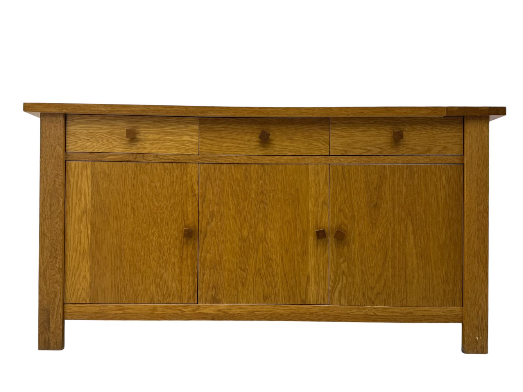 Contemporary oak sideboard, rectangular top with central contrasting plank, over three frieze drawers and three cupboards with enclosed shelving, on rectangular stile supports