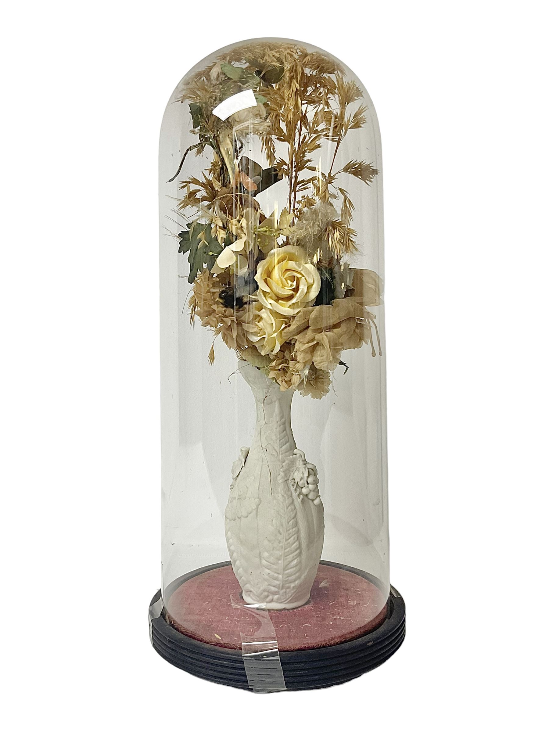 Victorian dome on ebonised wooden base, containing parian vase of silk and dried flowers, H47cm