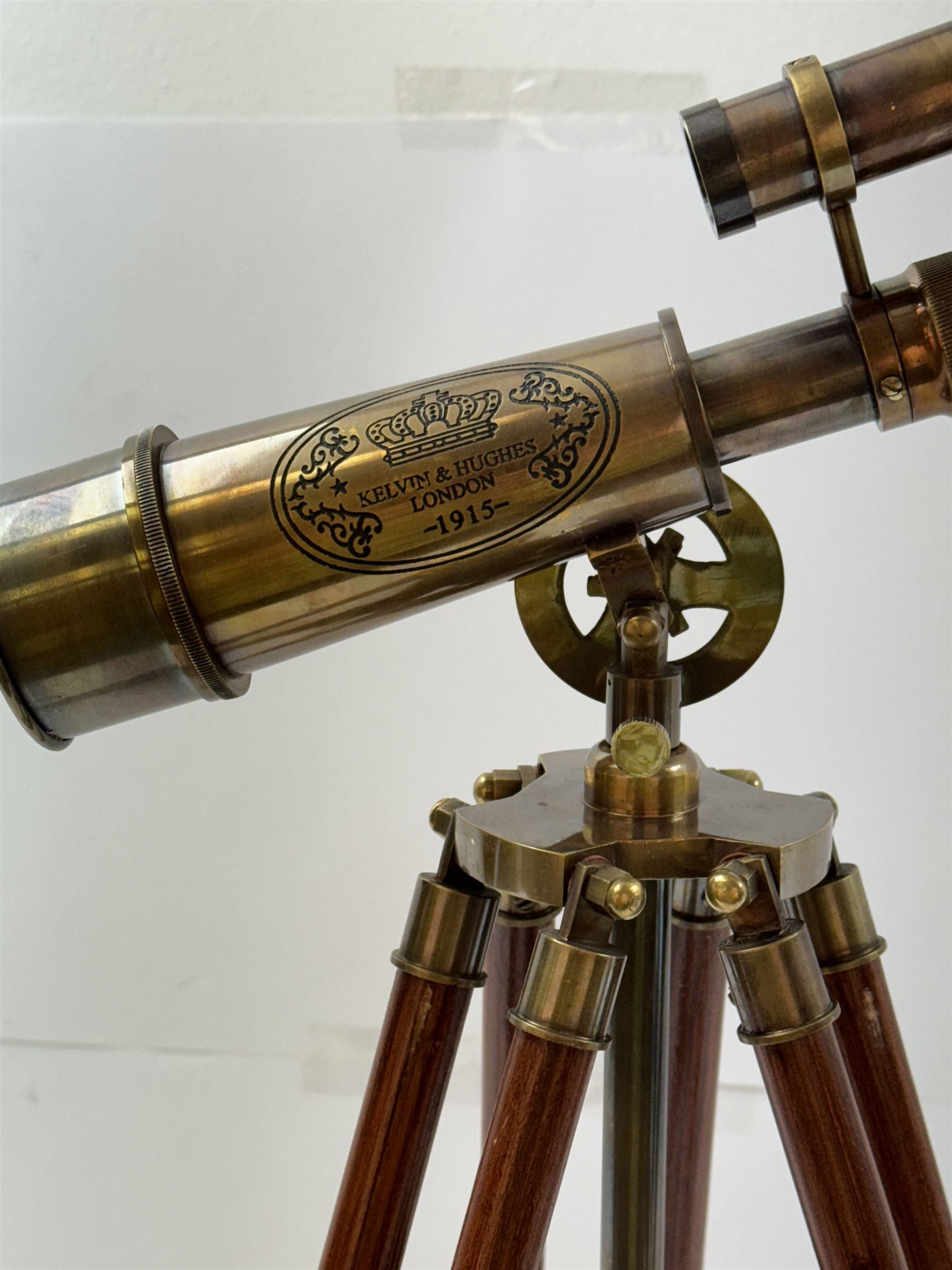 Brass telescope upon a wooden adjustable tripod, H55cm 