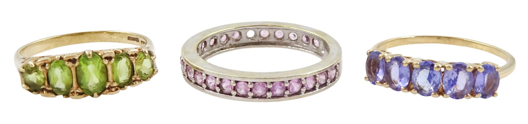 Gold five stone tanzanite ring, white gold pink sapphire full eternity ring and a five stone peridot ring, all hallmarked 9ct