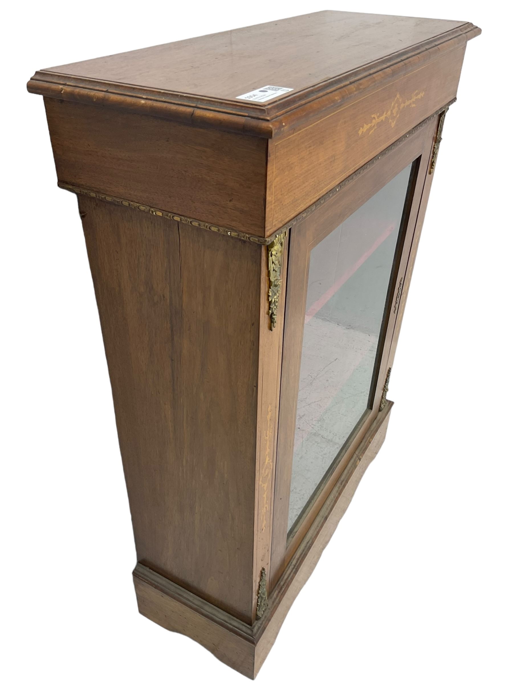 Victorian walnut pier cabinet, moulded rectangular top over inlaid frieze, enclosed by single glazed door, the uprights inlaid with extending stylised foliage decoration and cast gilt metal mounts, on moulded plinth base