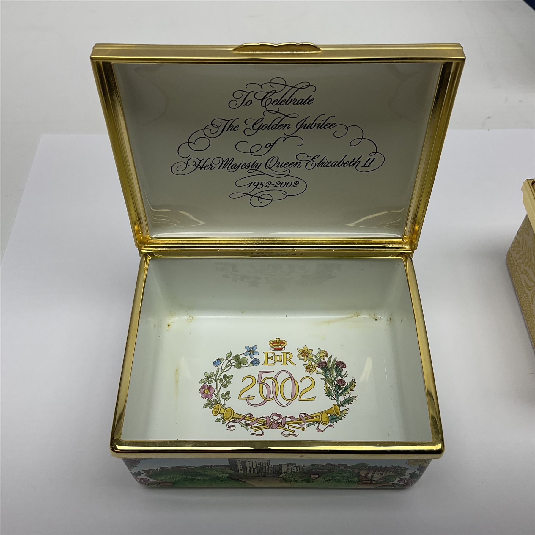 Two Halcyon Days enamel boxes, both of rectangular form, the first depicting Buckingham Palace, 'To Celebrate the Golden Jubilee of Her Majesty Queen Elizabeth', the second depicting the marriage of The Queen and Prince Philip, in celebration of their Diamond Wedding Anniversary, H4cm, W8.5cm, both boxed