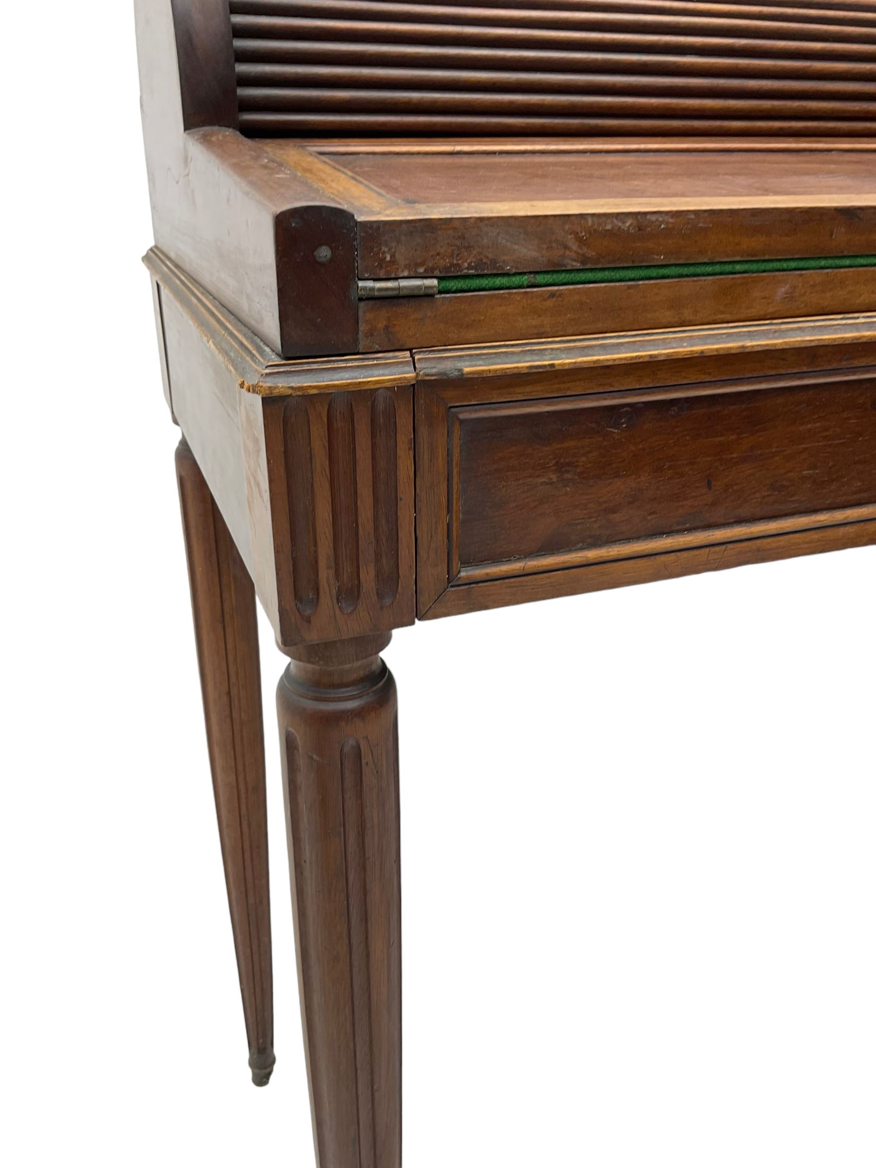 Early 20th century French plum pudding mahogany petite writing desk, barrel tambour roll top, fitted with a single cock-beaded drawer activating the tambour roll, the fold-over writing slope with inset writing surface supported by long drawer, fitted with three small drawers and pen rail, raised on fluted tapering supports