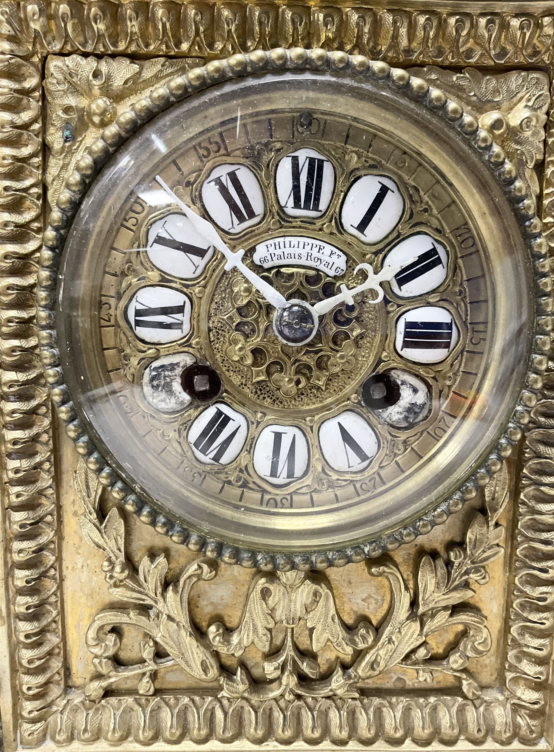 French - Brass cased 8-day mantle clock c1880, with a domed top surmounted by a pineapple finial, four reeded pilasters to the corners and raised on tapered feet, with a conforming dial with cartouche numerals, fleur-di -Lis hands and the name, Phillippe, 66 Palais Royal, Paris, twin train countwheel striking movement sounding the hours and half-hours on a bell.  With pendulum and key. 
