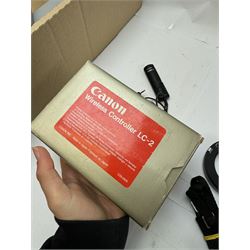 Collection of Canon camera accessories, predominantly for SLR cameras, including flashes, motor drives, quartz date back grips, filters, etc, mostly boxed or cased 