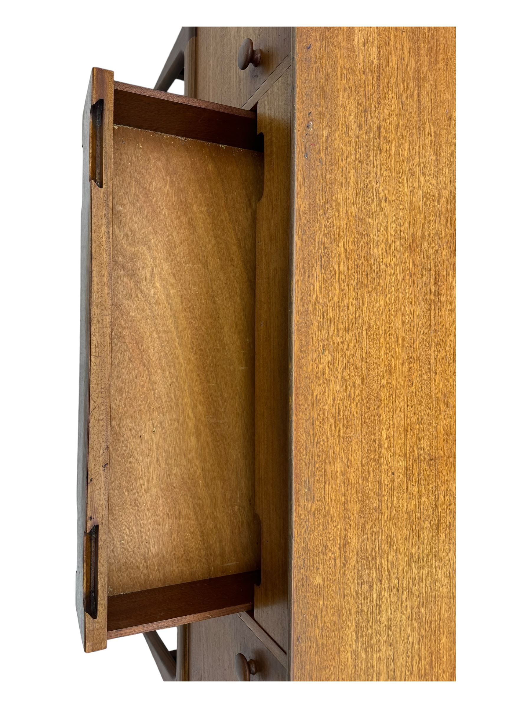 Younger - mid-20th century teak sideboard, rectangular top over three central drawers with recessed handles, flanked by two cupboard doors enclosing two shelves, on tapered supports joined by stretchers