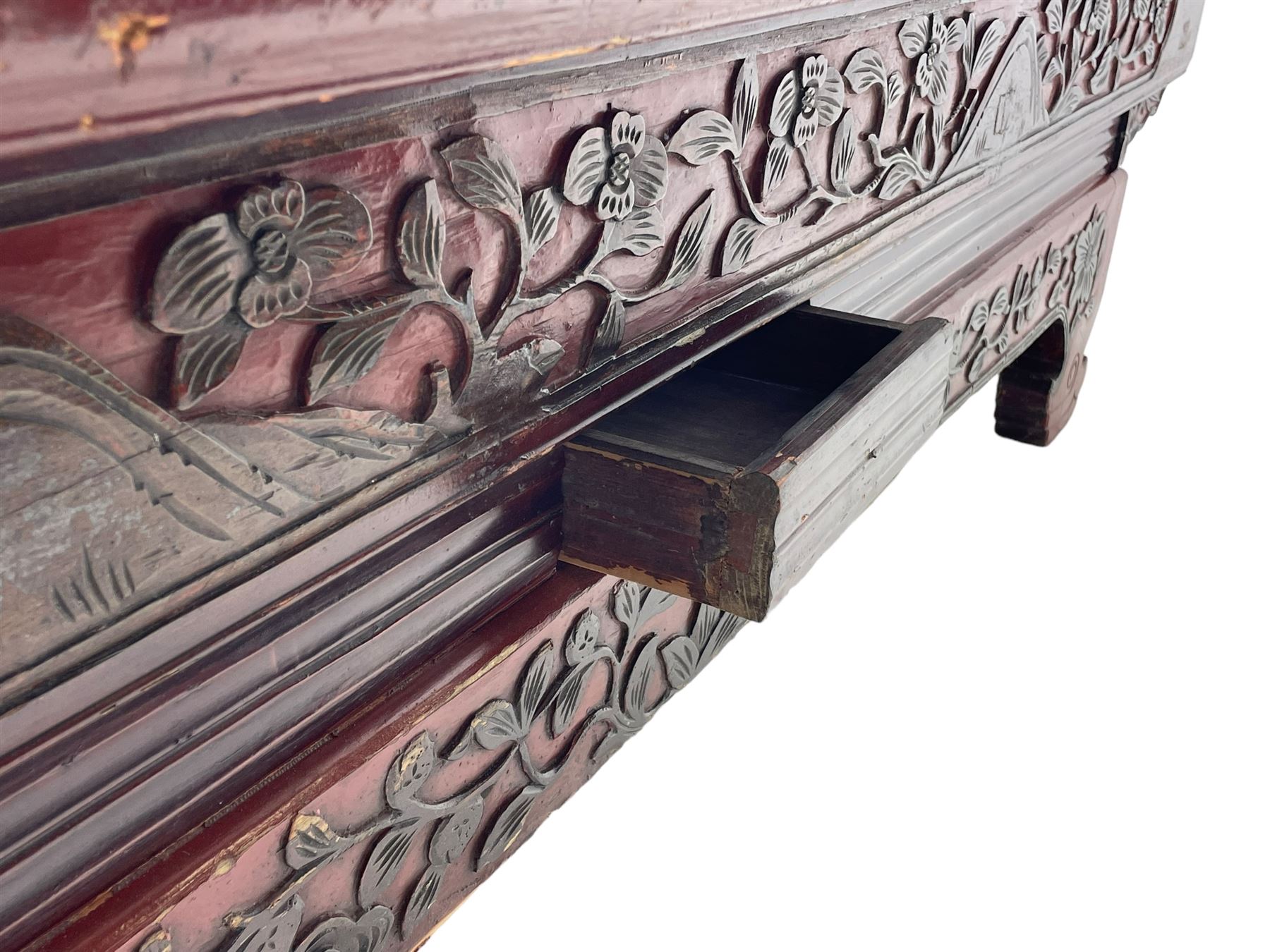 Mid-19th century Qing dynasty opium or wedding bed, Zhejiang province, rectangular top with weave cane work, the frieze rail carved with trailing leafy branches and flower heads, over moulded rail with small drawer, shaped base carved with further tailing foliate decoration terminating to shaped feet, united by stretchers 