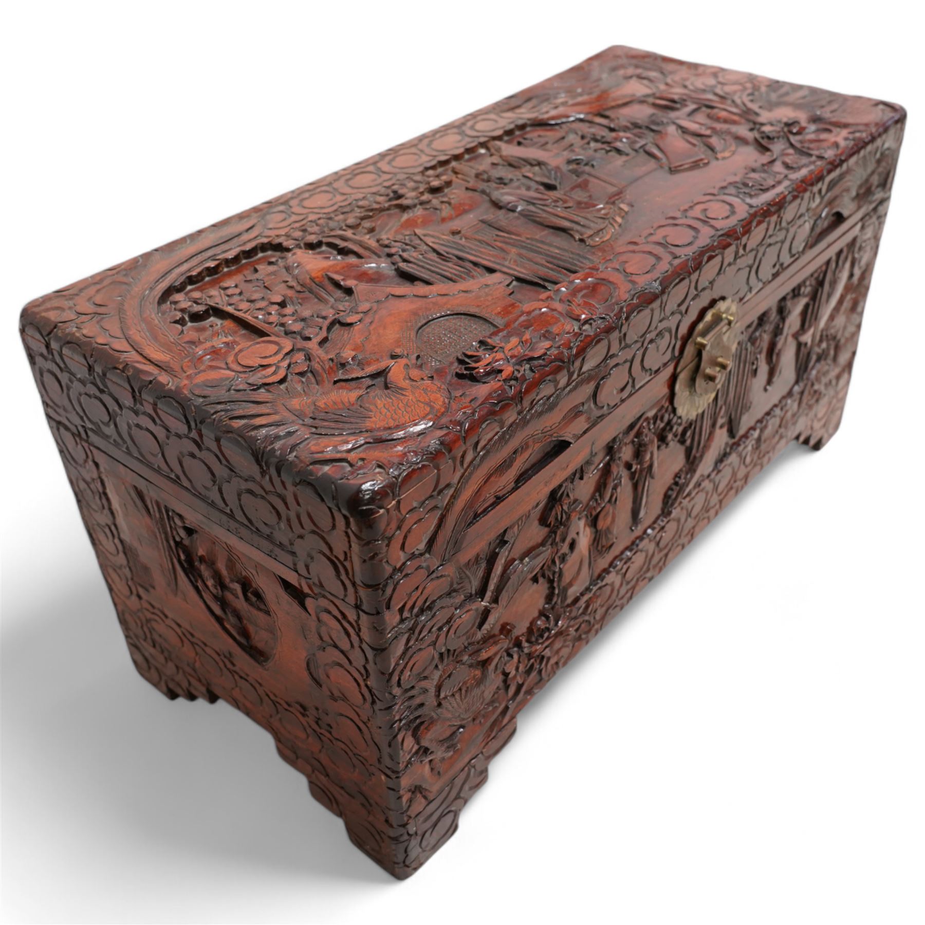 Chinese heavily carved and lacquered camphor wood blanket chest, rectangular hinged top, carved all-over with traditional figural and pagoda scenes with exotic birds, enclosed by a border of stylised clouds