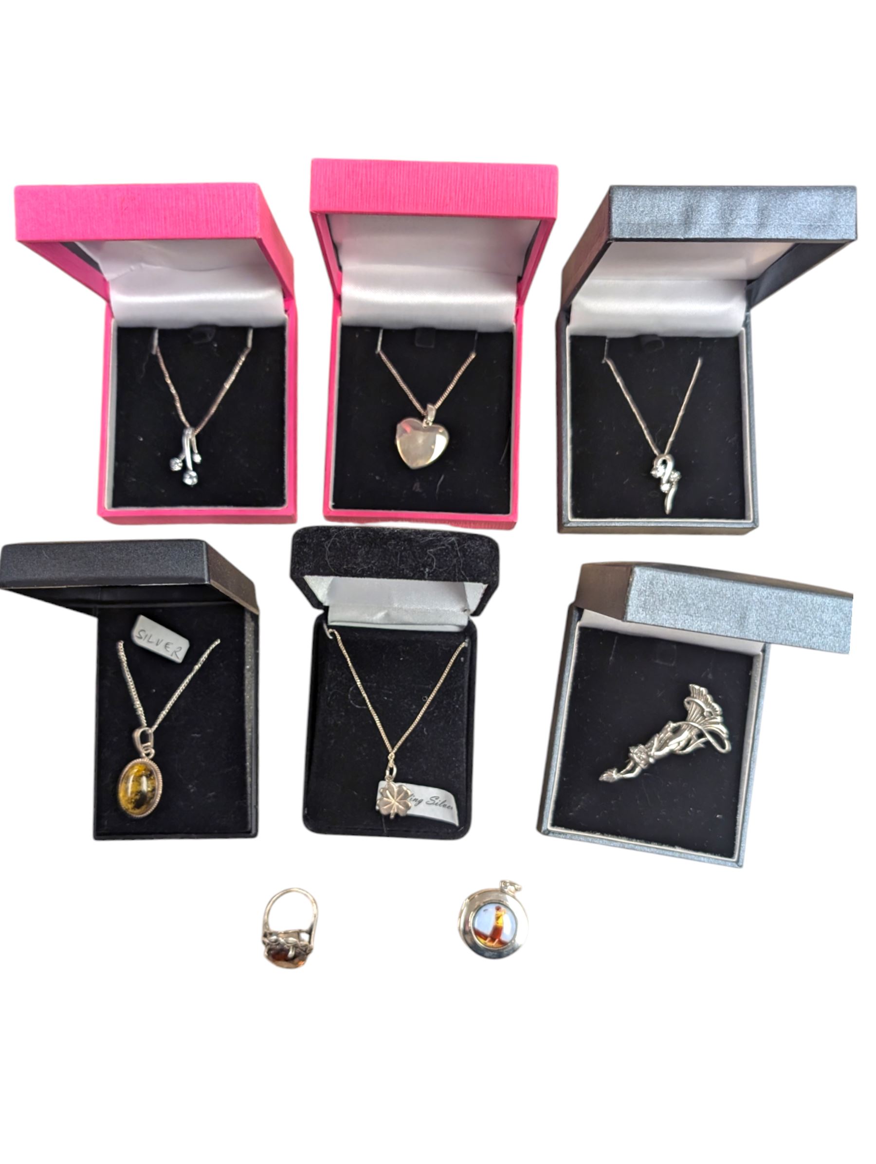 Silver jewellery, including five pendants/locket necklaces, brooch, enamel golf theme locket pendant and a paste ring, six boxed