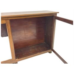 Early 20th century mahogany bookcase, rectangular top over two glazed doors, fitted with four adjustable shelves, on turned bun feet 