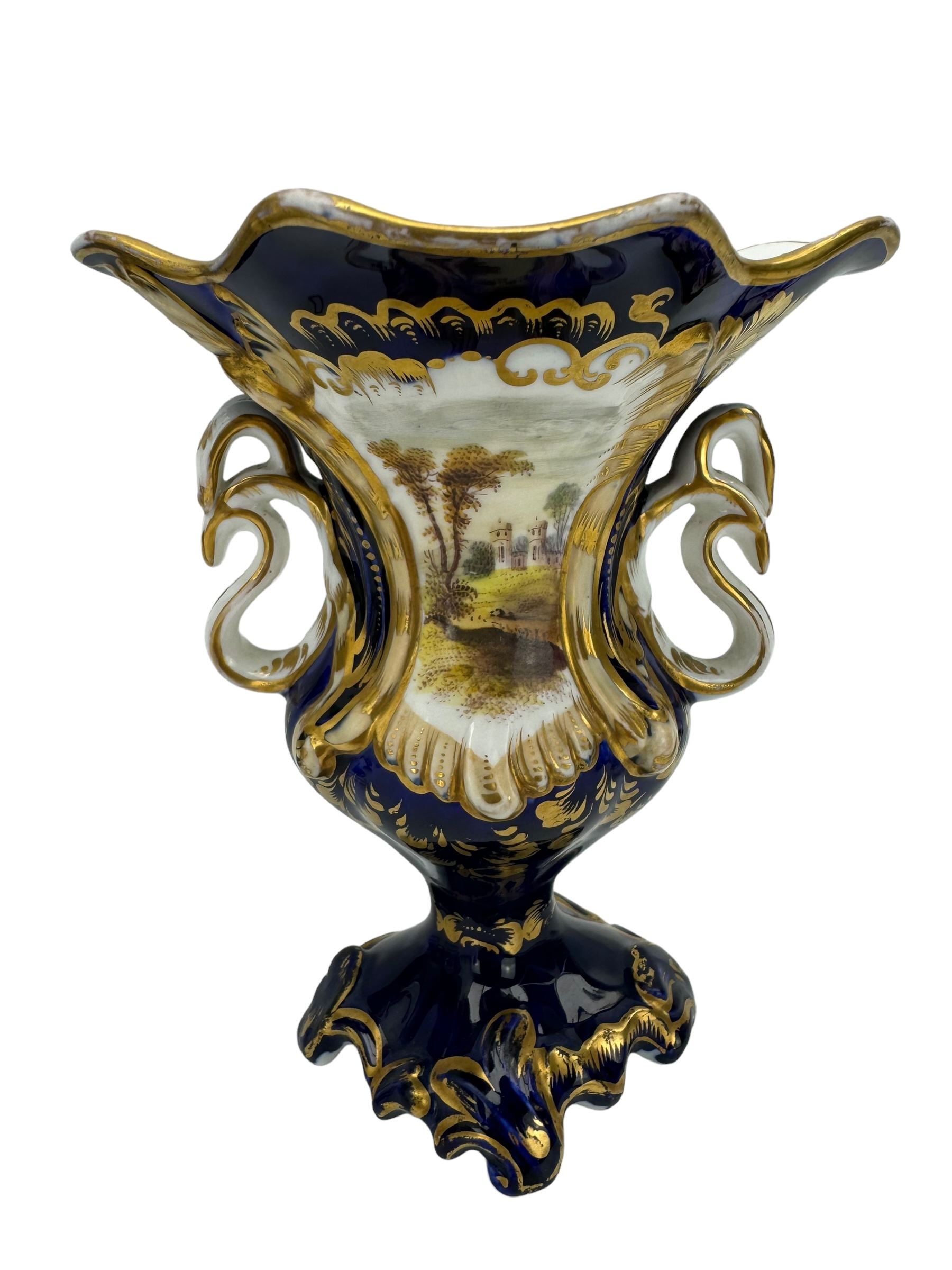 Samuel Alcock porcelain vase of footed two-handled form decorated with a panel of flowers and landscape verso, H16cm, 19th century porcelain vase with flared petal shaped rim, hand painted with a still life of shells, against a cobalt blue and gilt ground, small porcelain basket hand painted with a figure, and campana shaped urn (4)