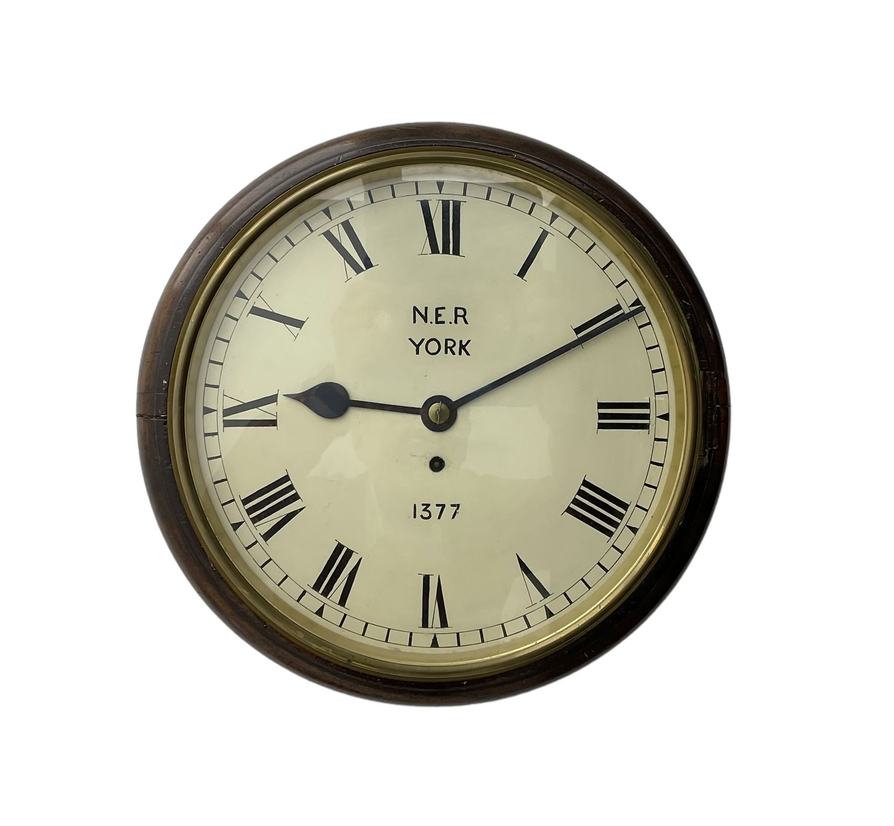 English - 8-day single train Fusee wall clock, with a mahogany dial surround and brass bezel, painted dial with Roman numerals , minute track and steel spade hands, dial inscribed N.E.R. YORK .1377. wire driven fusee with square plates and recoil anchor escapement. With pendulum. 