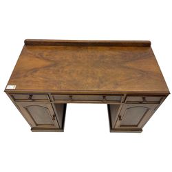 Victorian walnut twin pedestal desk or dressing table, raised back over quarter-matched veneered top, fitted with three drawers and two cupboards, enclosed by figured panelled doors, on moulded plinth base