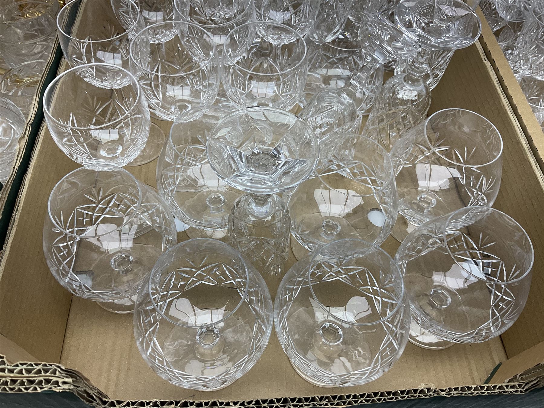 Large collection of glassware, to include twelve wine glass set, twelve champagne flutes, eight brandy glasses, two decanters etc, in three boxes  