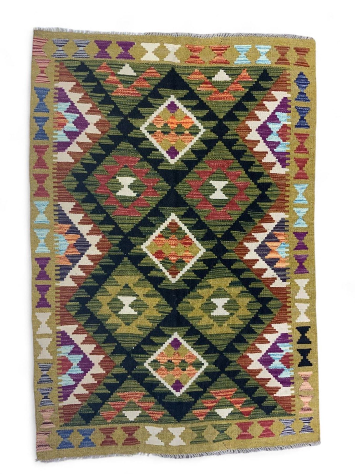 Chobi kilim multi-coloured rug, the field decorated with various lozenges with dark indigo borders, enclosed by a guard band with repeating broken-lozenge design