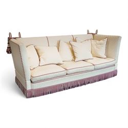 Grande Knole four-seat sofa, upholstered in geometric lozenge pattern cream fabric with burgundy and cream twist piping and fringe, on castors