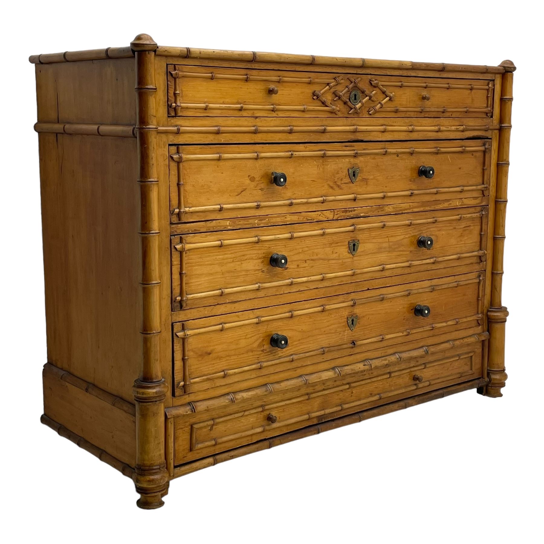 Victorian pine and simulated bamboo chest, fitted with five drawers, the drawer fronts decorated with applied simulated bamboo mounts and turned ebonised handles, on turned front feet