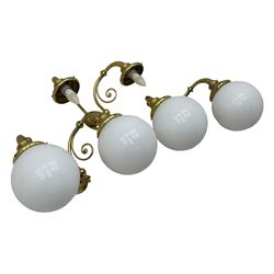 Two brass double-arm wall mounted lights, each with frosted glass globes and scrolled arms (W50cm, D26cm, H31cm); matching central double-arm light with candle-style fittings (W42cm, D24cm, H22cm)