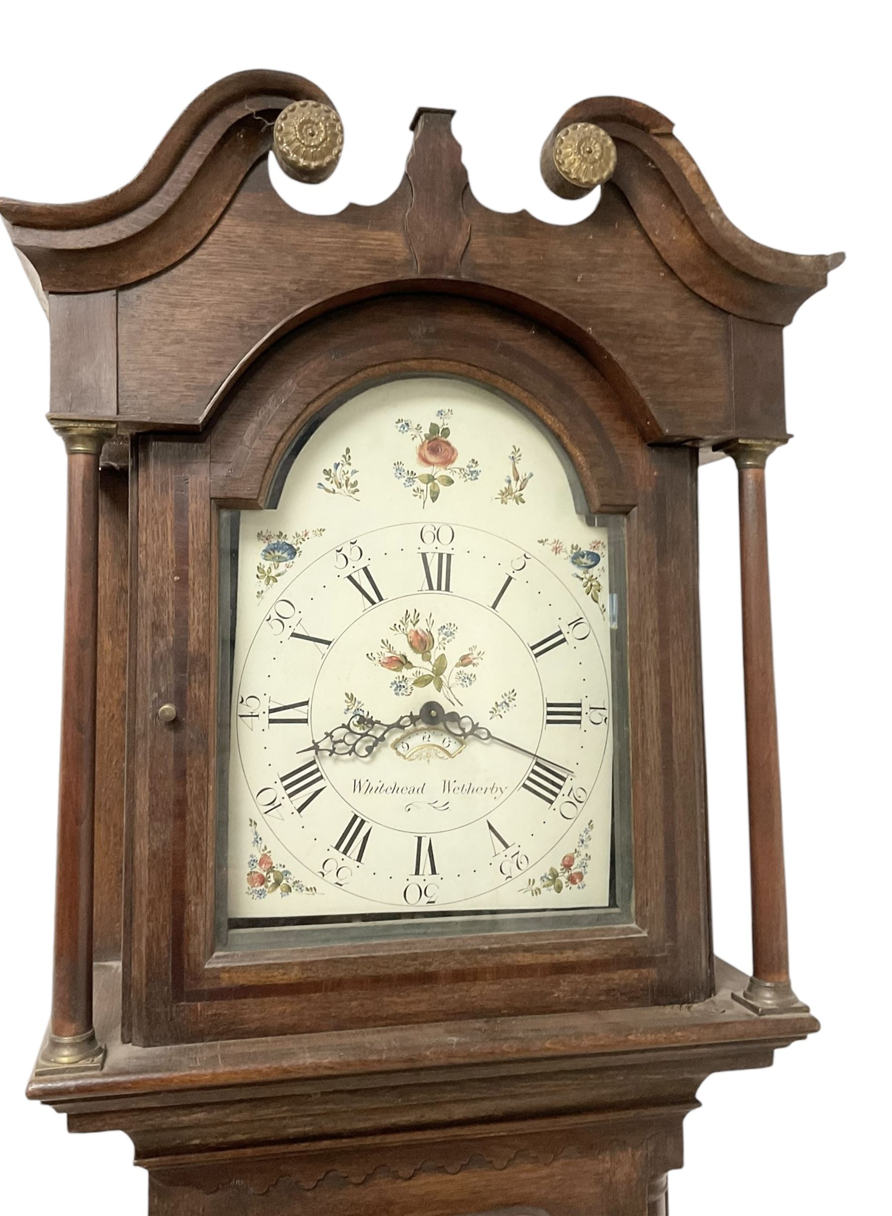 Whitehead of Wetherby - 30hr oak cased longcase clock c1790 with a swans necked pediment  and brass parterre, break arch hood door and trunk with quarter columns and long trunk door, on a stepped plinth with a raised panel and bracket feet, early painted dial with Roman numerals and five-minute Arabic's, floral decoration to the arch and spandrels, dial pinned directly to a rope driven movement with a countwheel strike.  With weight and pendulum.