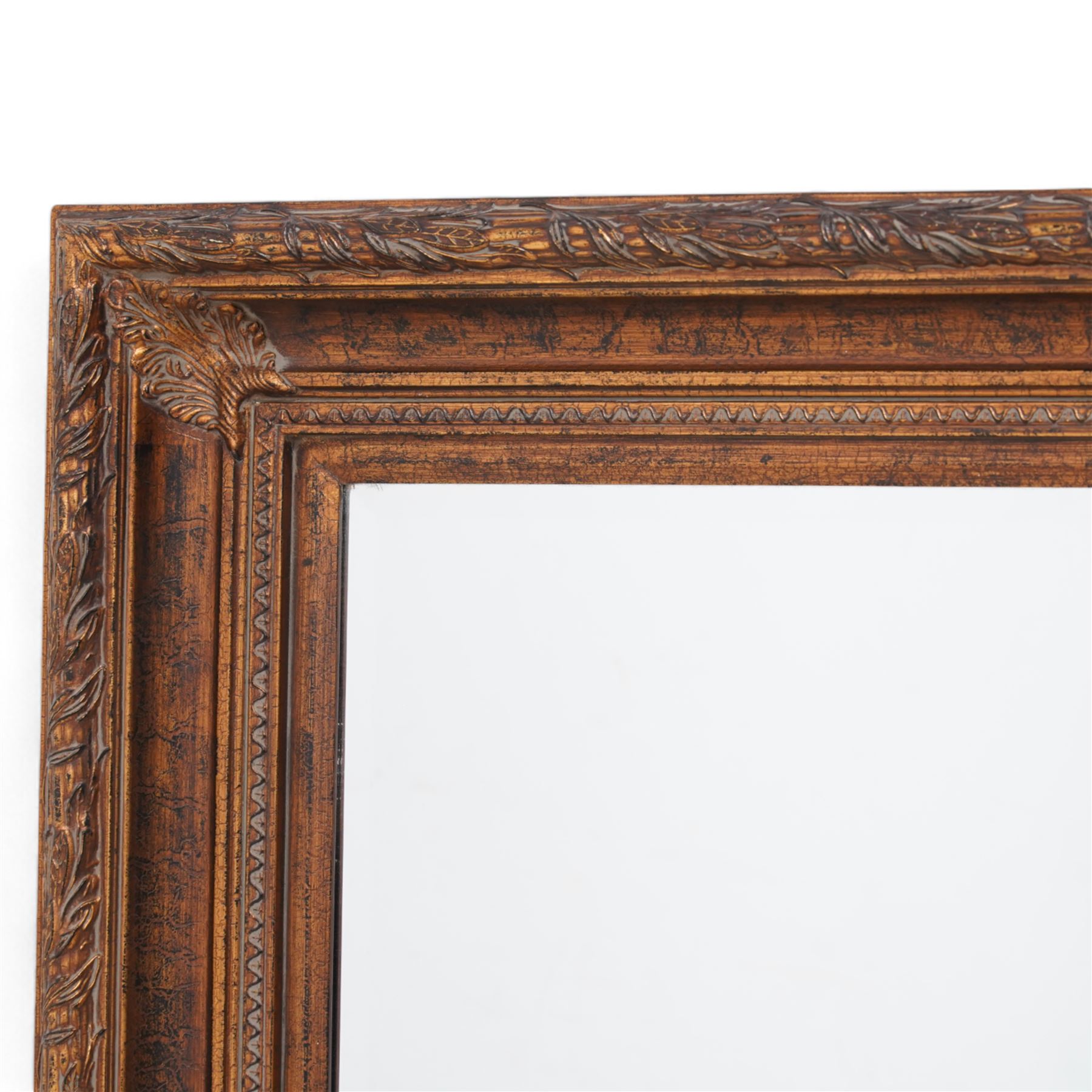 Gilt framed wall mirror, the moulded rectangular frame decorated with trailing laurel leaves and acanthus leaves, bevelled mirror plate 