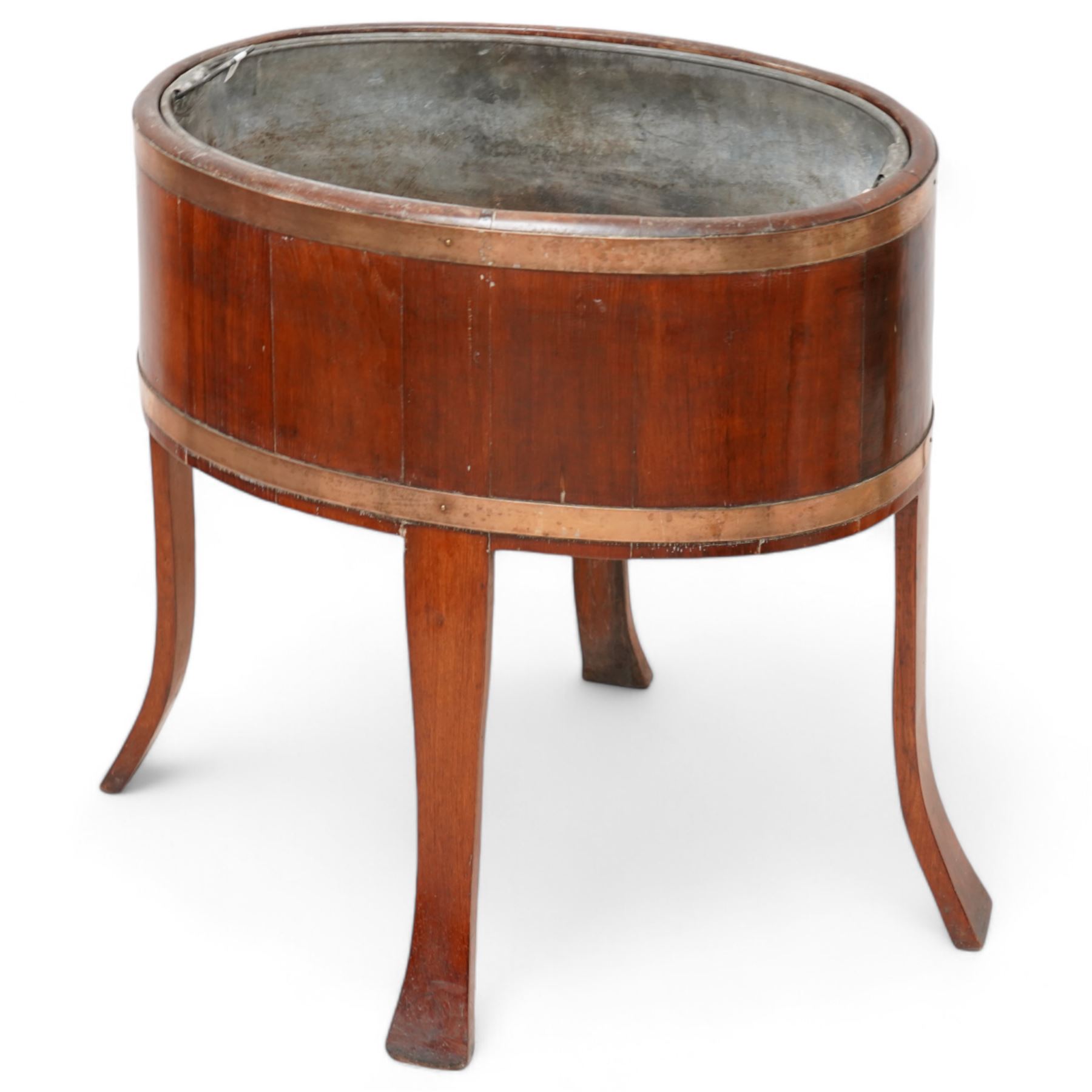 Late 19th century coopered mahogany wine cooler, oval form with metal liner and brass bands, on out splayed supports, bearing Sotherby's Country House sale label '2 May 1990' (Wherwell Priory)