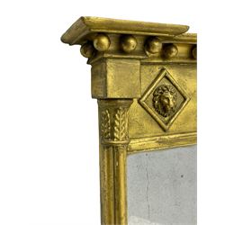 Regency giltwood and gesso pier mirror, projecting moulded cornice with globular mounts, the frieze decorated with three lion masks within lozenges, cluster column uprights with leaf decorated capitals, bevelled mirror plate