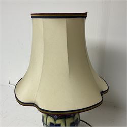 Moorcroft table lamp, of baluster form, decorated in the Violet pattern, on wooden plinth, with accompanying cream shade of lobed form, with piped detail, H23cm (excluding fitting)