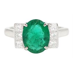 18ct white gold emerald and diamond ring, single oval cut emerald, each side set with thre...