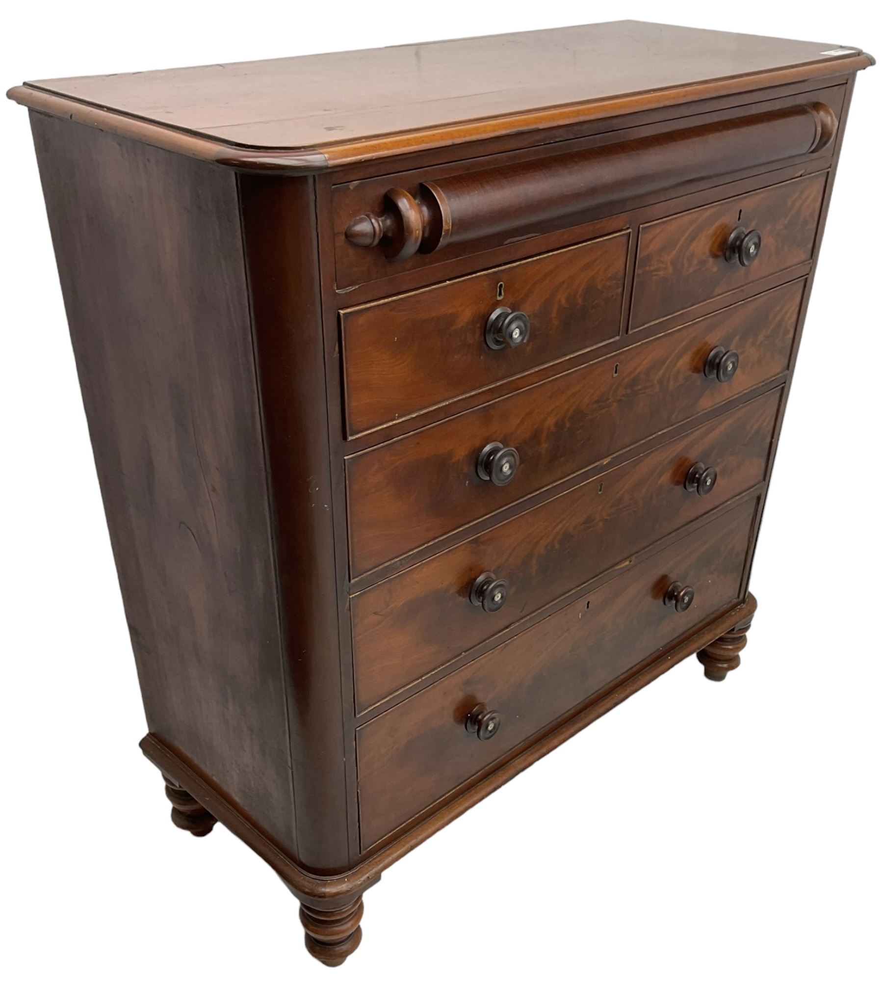 Victorian mahogany chest, rectangular moulded top with rounded corners, the frieze drawer with turned half column mount, two short and three long cock-beaded drawers, on turned feet